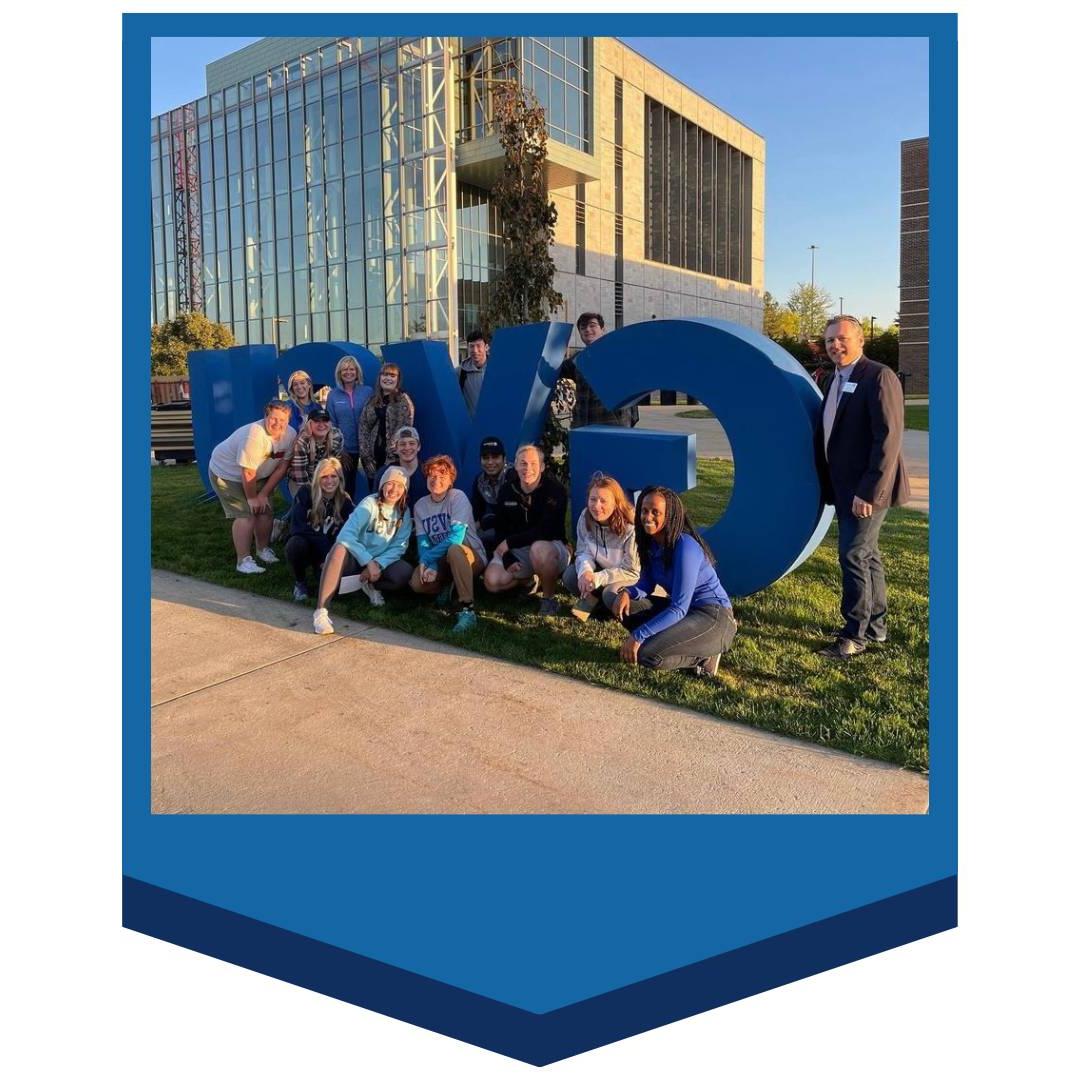 Students in front of GVSU letters